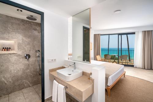 a bathroom with a bed and a sink and a shower at Yalihan Aspendos in Alanya