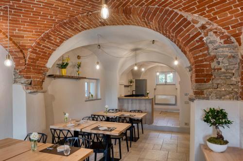 a dining room with tables and a brick wall at Casa Calleri in Briaglia