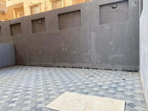 a garage with a wall and a tile floor at Via broker in Cairo