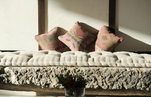 a bed with pillows on it in a room at Delser Verona Manor House in Verona