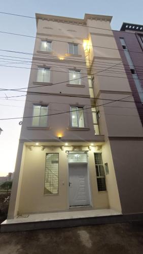 a tall building with a door on the side of it at Continental Boys Hostel R-2 Johar Town in Lahore