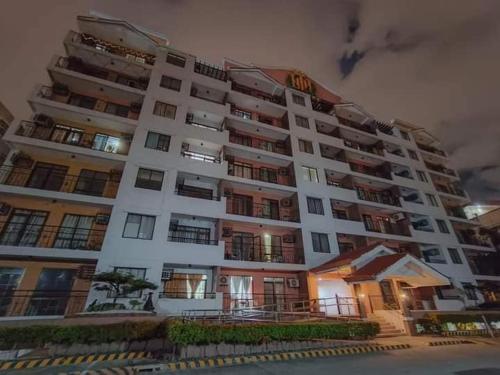 a large white apartment building at night at Cheap 2BR Fully Furnished Condo in Davao City in Davao City