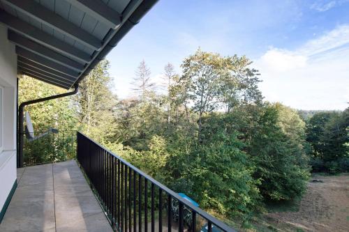 a balcony of a house with a view of trees at Kaiserchalet in Höchenschwand