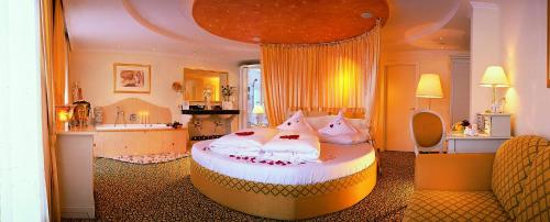 a bedroom with a large bed with pillows on it at ... mein romantisches Hotel Toalstock in Fiss