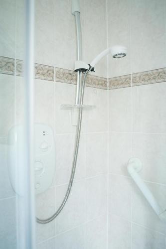 a shower in a bathroom with a glass door at Darmeid House in Kirk of Shotts