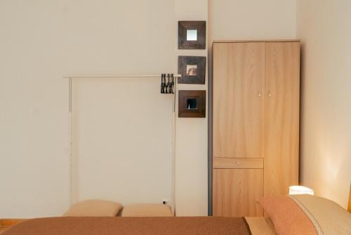 a bedroom with a closet and a bed with chairs at La Terrazza sul Reno - in pieno centro-due passi da Villa Chiara - comodo Unipol Arena in Casalecchio di Reno