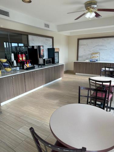 a waiting room at a fast food restaurant with a table and chairs at Days Inn & Suites by Wyndham Opelousas in Opelousas