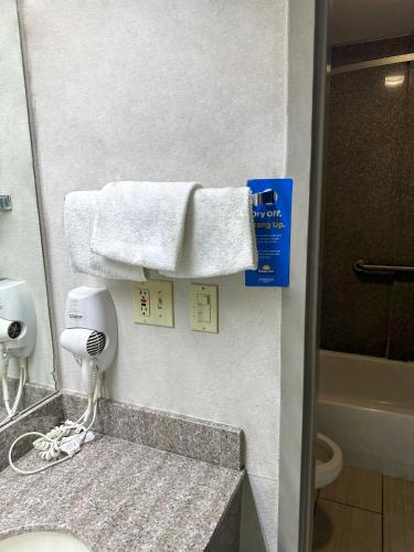 a bathroom with a sink and a towel at Days Inn & Suites by Wyndham Opelousas in Opelousas