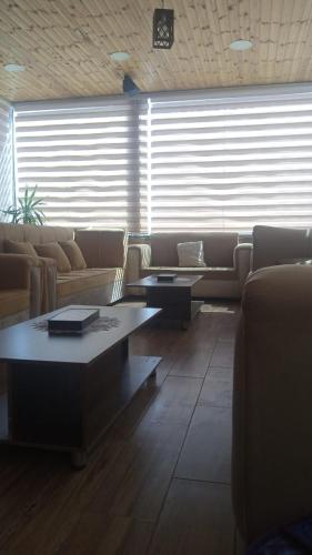 a living room with couches and a coffee table at Petra cabin Roof top hostel in Wadi Musa
