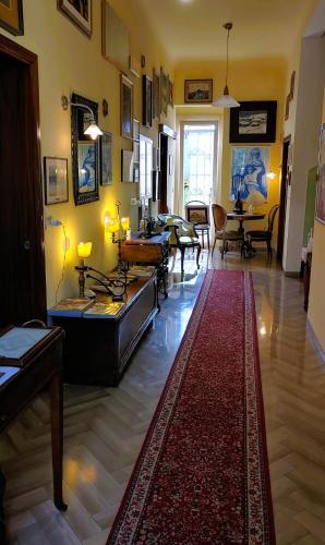 a living room with a red rug on the floor at Villa Liberty B&B in Fano