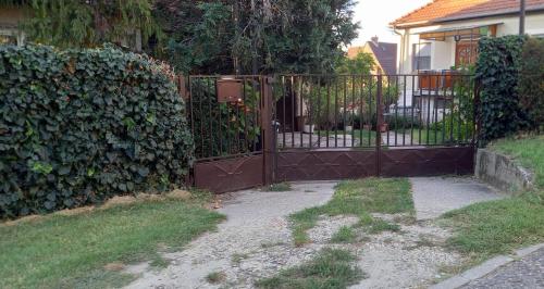 an iron gate in front of a fence at Little Bear Apartment in Mogyoród