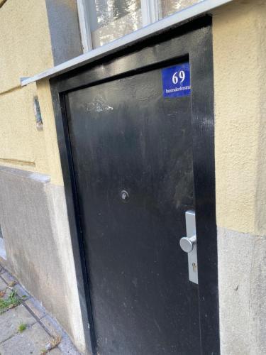 a black door with a sign on the side of a building at Deep City Vienna in Vienna