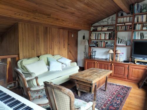 a living room with a couch and a table at Chalet Nicouski in La Salle Les Alpes