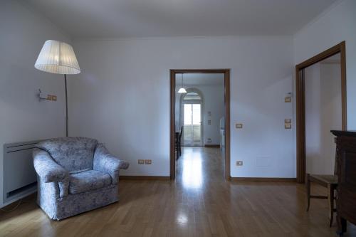 a living room with a chair and a hallway at Agriturismo Ai Prati in Perugia