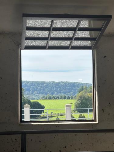 a window with a view of a green field at Chambery Inn in Lee