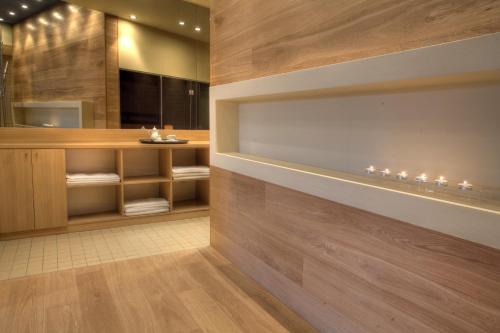 a bathroom with wooden walls and a vanity with lights at Euphoria Club Hotel in Borovets