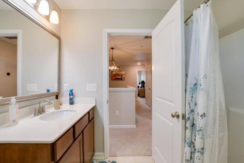 a bathroom with a sink and a mirror at Greer Family Home with Library, Sunroom and Backyard! in Duncan