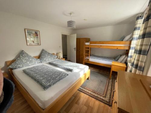 una camera con 2 letti a castello e un tavolo di Alpine Blue Apartments a Griesen