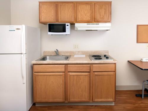 a kitchen with a sink and a white refrigerator at Extended Stay America Select Suites - Indianapolis - Plainfield in Plainfield