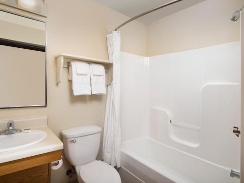 a bathroom with a toilet and a tub and a sink at Extended Stay America Select Suites - Indianapolis - Plainfield in Plainfield