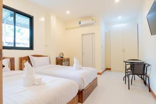 Postel nebo postele na pokoji v ubytování Chotika Hotel โรงแรมโชติกา ณ เชียงคาน
