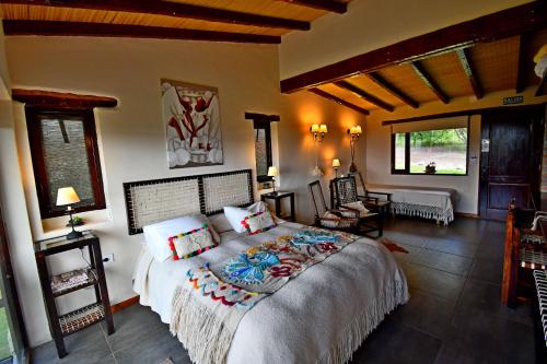 a bedroom with a large bed in a room at Posada La Soñada in Tafí del Valle