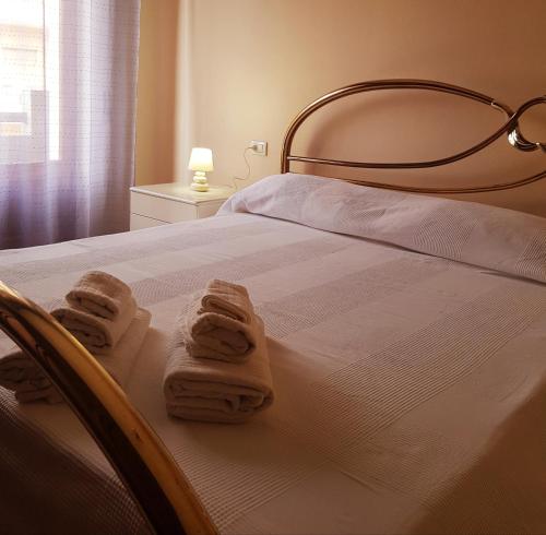 ein Schlafzimmer mit einem Bett mit Handtüchern darauf in der Unterkunft Il Fenicottero Rosa Casa Sanzio in Quartu SantʼElena