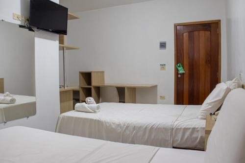 En eller flere senger på et rom på Inácios Hotel ltda