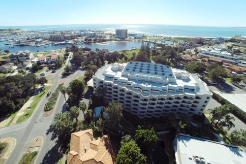 a large building with a large clock on top of it at Atrium Hotel Mandurah in Mandurah