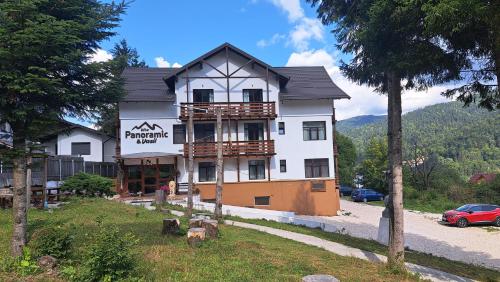 a building with a sign on the side of it at Vila PANORAMIC Busteni in Buşteni