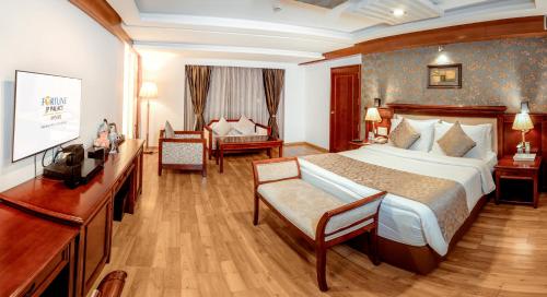 a hotel room with a large bed and a television at Fortune JP Palace, Mysore - Member ITC Hotels' Group in Mysore