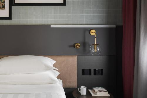 a bedroom with a bed and a table with a lamp at iQ Hotel Firenze in Florence