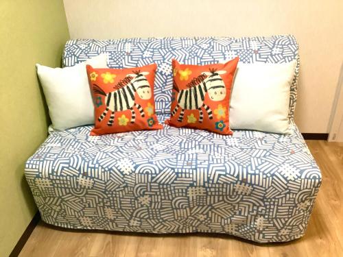 a couch with three pillows on it in a room at 雅別邸 in Kyoto