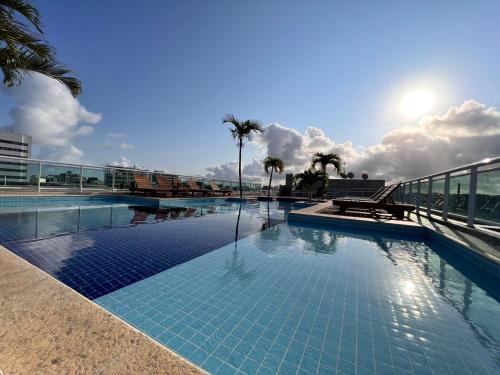 a large swimming pool on top of a building at Apartamento JTR Cond Beira Mar - Castelo B Temporada in Maceió