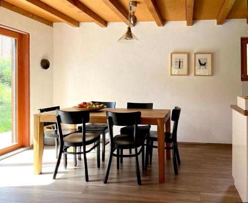 a dining room with a wooden table and chairs at Chalet près des bisses in Savièse