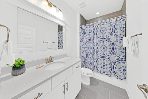 a bathroom with a sink and a toilet and a shower at Grande Pointe Sea Shell in Inlet Beach