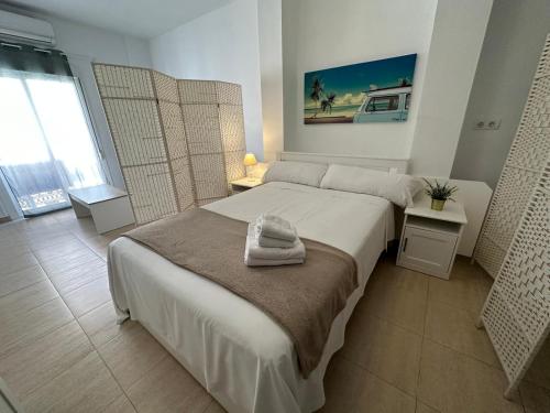 a bedroom with a bed with a towel on it at Málaga Center Flat. Carmen City Center Roof-Terrace Boutique in Málaga