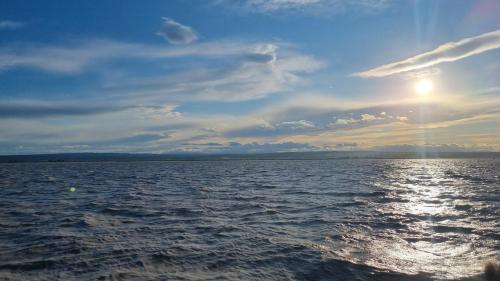 a view of the ocean from a boat in the water at BIRKENHOF GOLS - B & B - Wohlfühl Hotel mit Wochenend-Restaurant in Gols