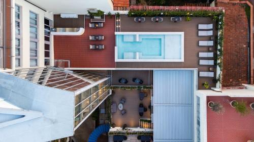 an aerial view of a building with a swimming pool at iQ Hotel Firenze in Florence