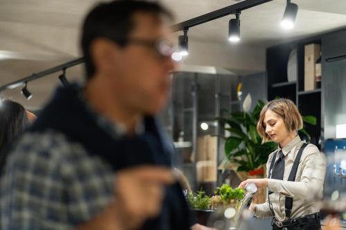 a man and a woman standing in a restaurant at iQ Hotel Firenze in Florence