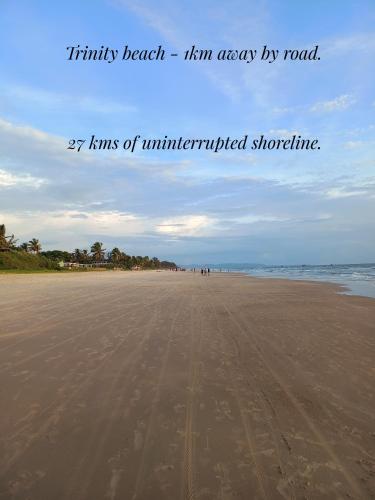a picture of a beach with the words infinity beach him easy by road at Palm Grove Cottages - Leisure Resort in Benaulim