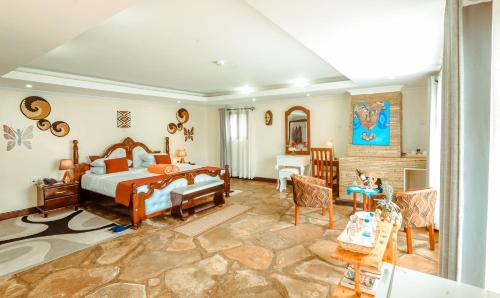 a bedroom with a bed and a living room at Ingagi Park View Lodge in Kinigi