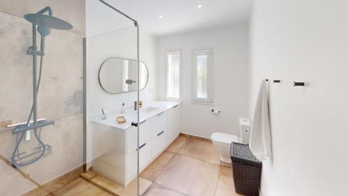 a bathroom with a shower and a sink and a mirror at El Chaparral - Renovated Villa in La Cala in Mijas Costa