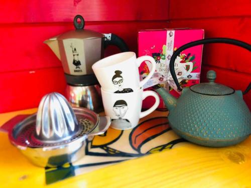 a table with a tea pot and cups on it at Roulotte Bohème en Provence, Terra Luna, Valensole in Valensole