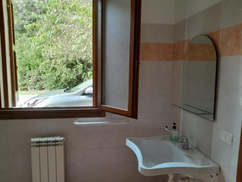a bathroom with a sink and a window at La Rizza in Bentivoglio