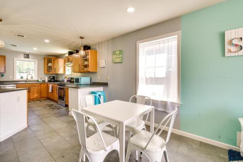 a kitchen with a table and chairs in a kitchen at The 1818 Home with Porch and Grill - 1 Mi to Beach! in Lake Como