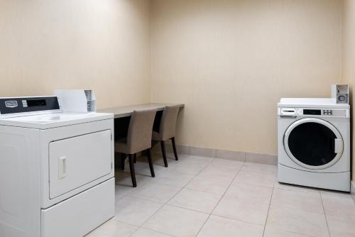 a laundry room with a washing machine and a table at Hilton Garden Inn Wayne in Wayne