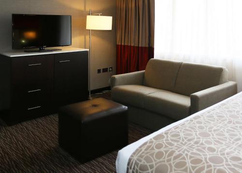 a hotel room with a bed and a chair and a television at DoubleTree by Hilton Hotel Nottingham - Gateway in Nottingham