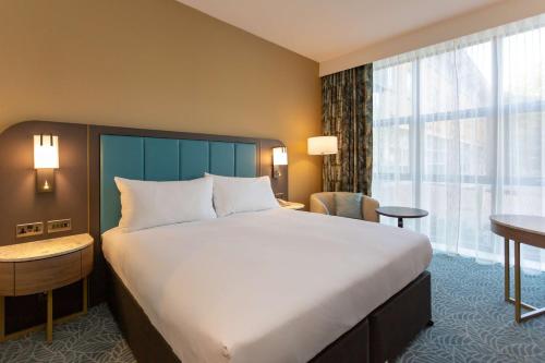 a bedroom with a large bed and a large window at DoubleTree by Hilton Hotel Nottingham - Gateway in Nottingham
