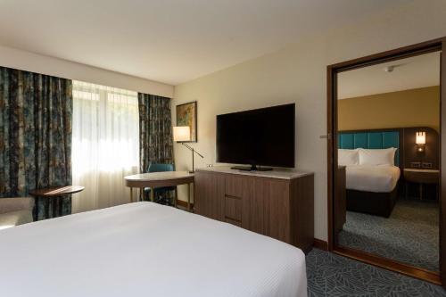 a hotel room with a bed and a flat screen tv at DoubleTree by Hilton Hotel Nottingham - Gateway in Nottingham